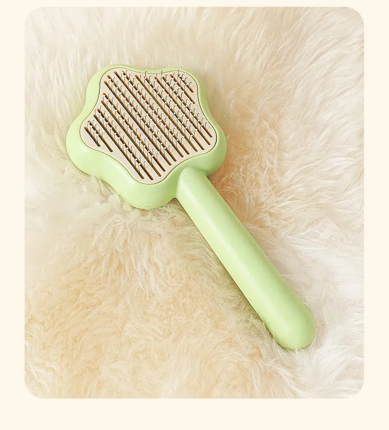Self-cleaning stainless steel pet comb with green handle, showing the 20cm length and needle teeth