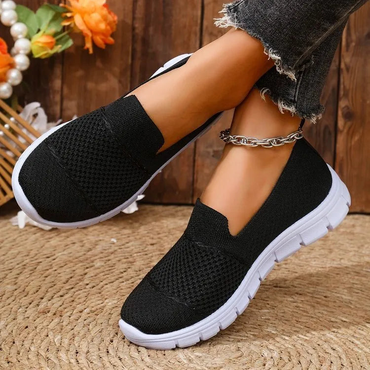Women's mesh breathable flat casual shoes in black, round toe, PVC sole, side view