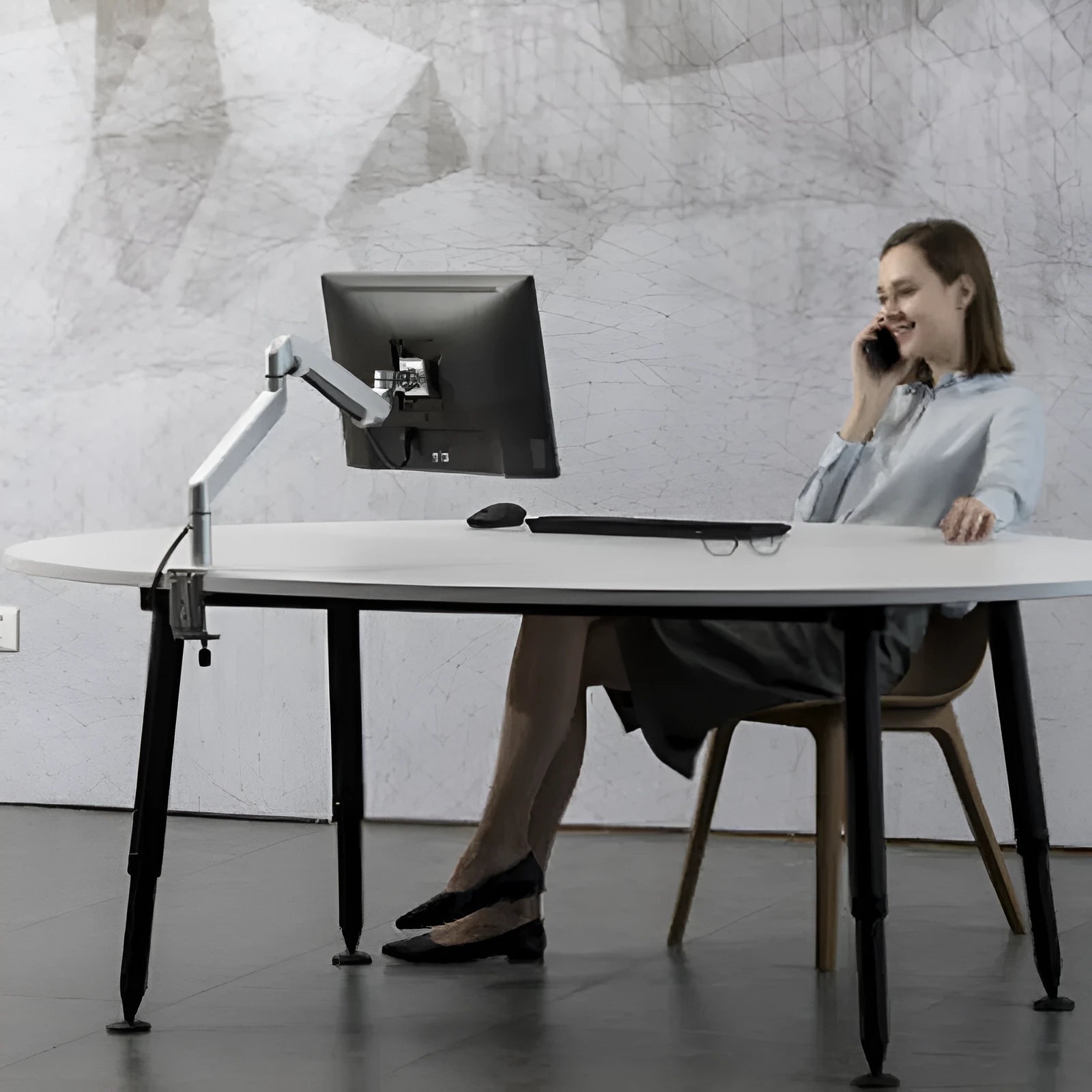 Aluminium alloy computer stand with adjustable arm bracket in silver colour supporting a laptop
