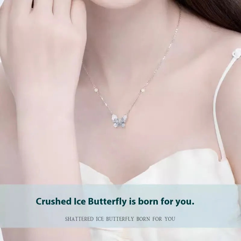 Close-up of a silver necklace with a detailed ice rain butterfly pendant on an O-ring chain.