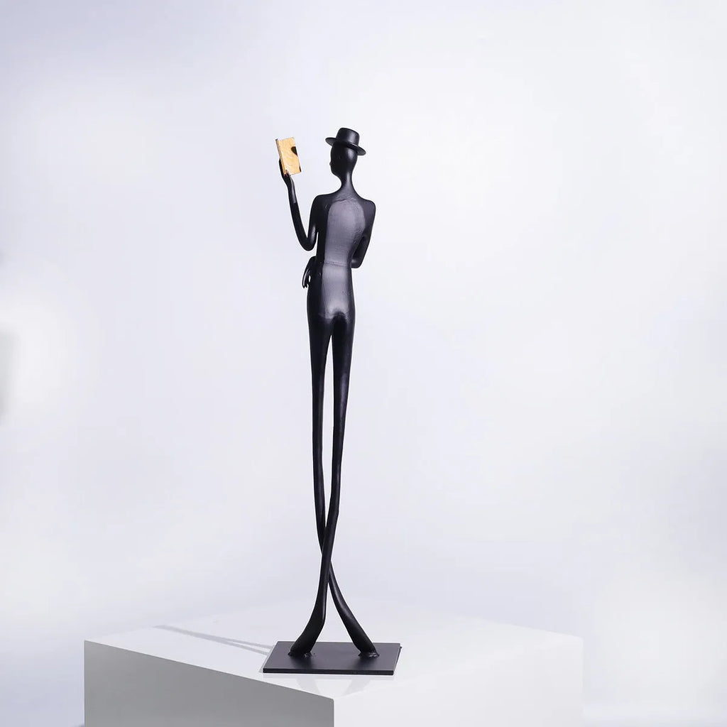 Black cast aluminium desktop sculpture of reading woman measuring 51 cm tall