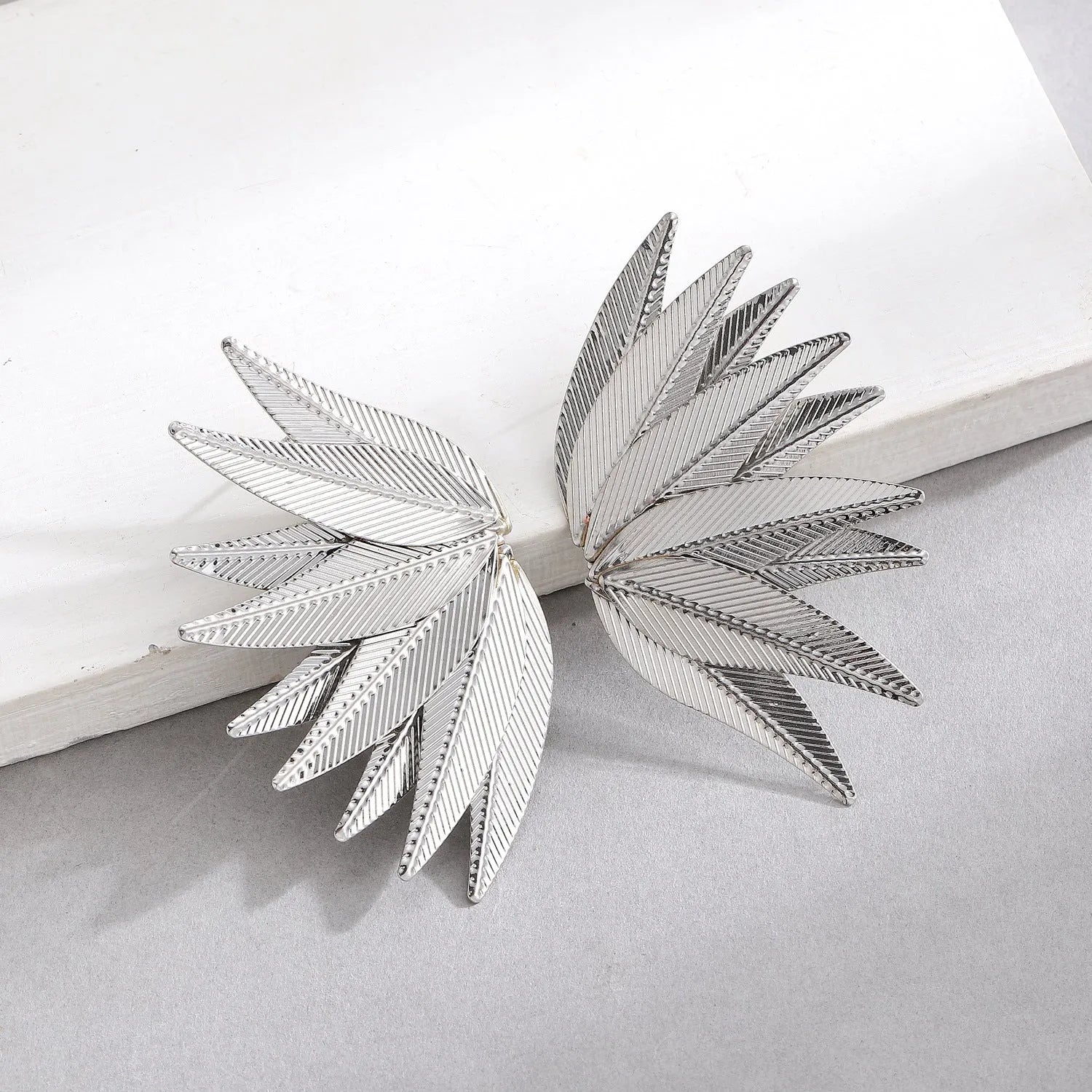 Gold and white leaves patch alloy earrings with leaf design texture