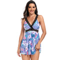 Woman wearing a printed V-neck swimsuit cover-up dress at the beach.