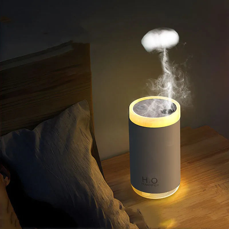 White USB jellyfish smoke ring humidifier with warm night light on a wooden desk