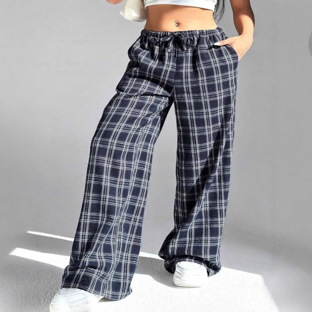 Women's blue plaid trousers with elastic drawstring waist and patch pockets laid flat