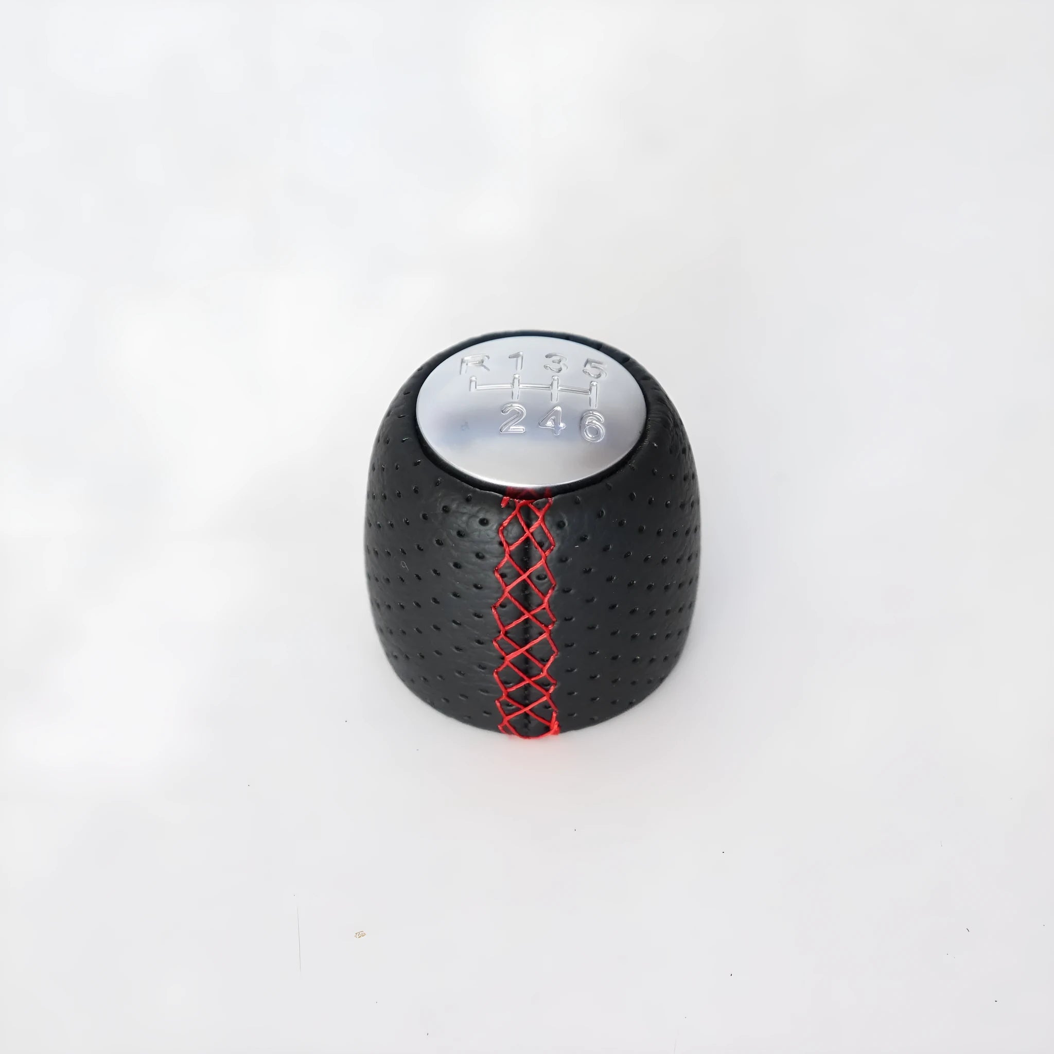 Sewn wrapped perforated leather gear knob for Alpha car in black, red, or white with matte or silver cover.
