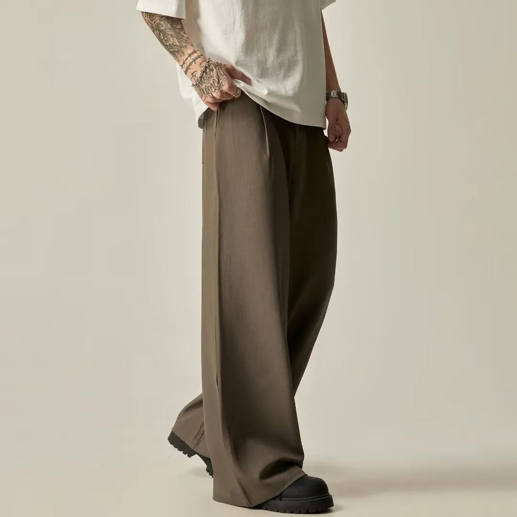 Men's solid black wide-leg casual trousers with a vertical tube design on a mid-waist.