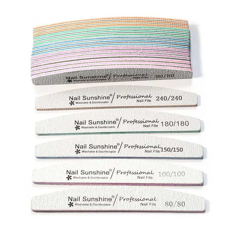 Grey half-moon shaped nail file with washable grit surface on a plain background.