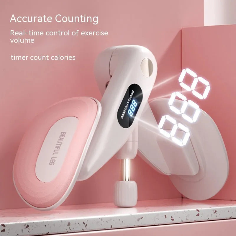 Grey coloured pelvic floor muscle trainer with a counter display, held in hand.