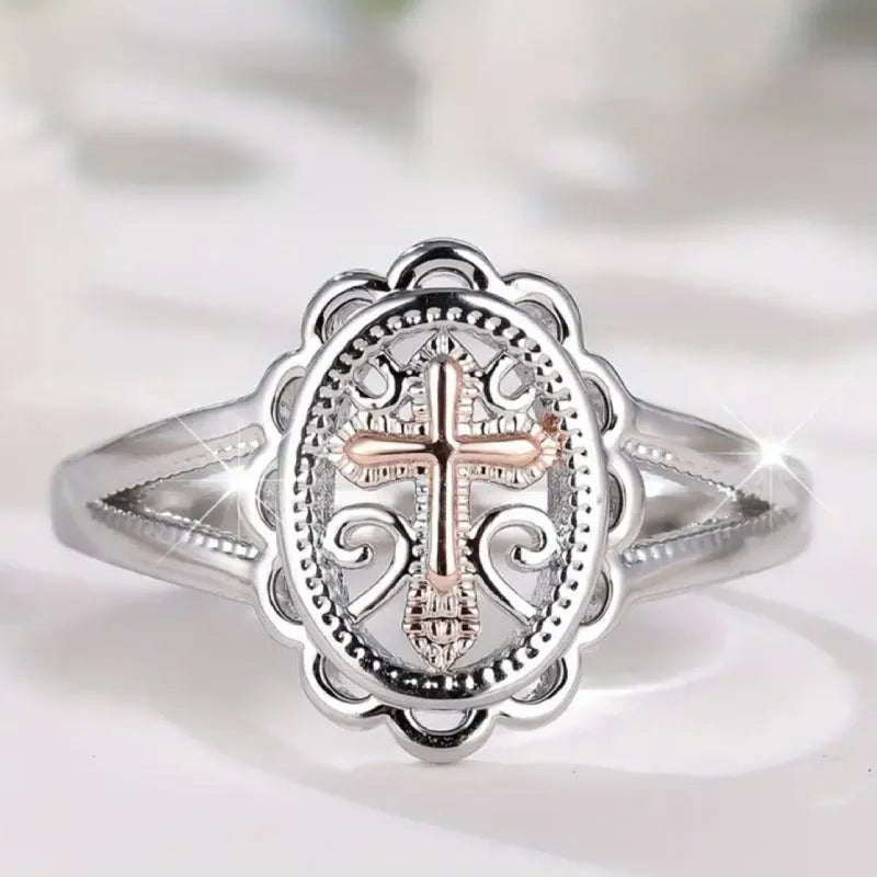 Silver cross and lace patterned alloy ring for women on a white background.