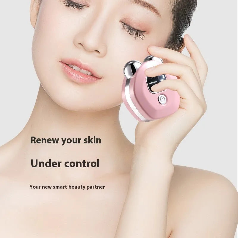 Portable white handheld facial massage instrument with a dual-roller head for micro current and hot compress therapy.