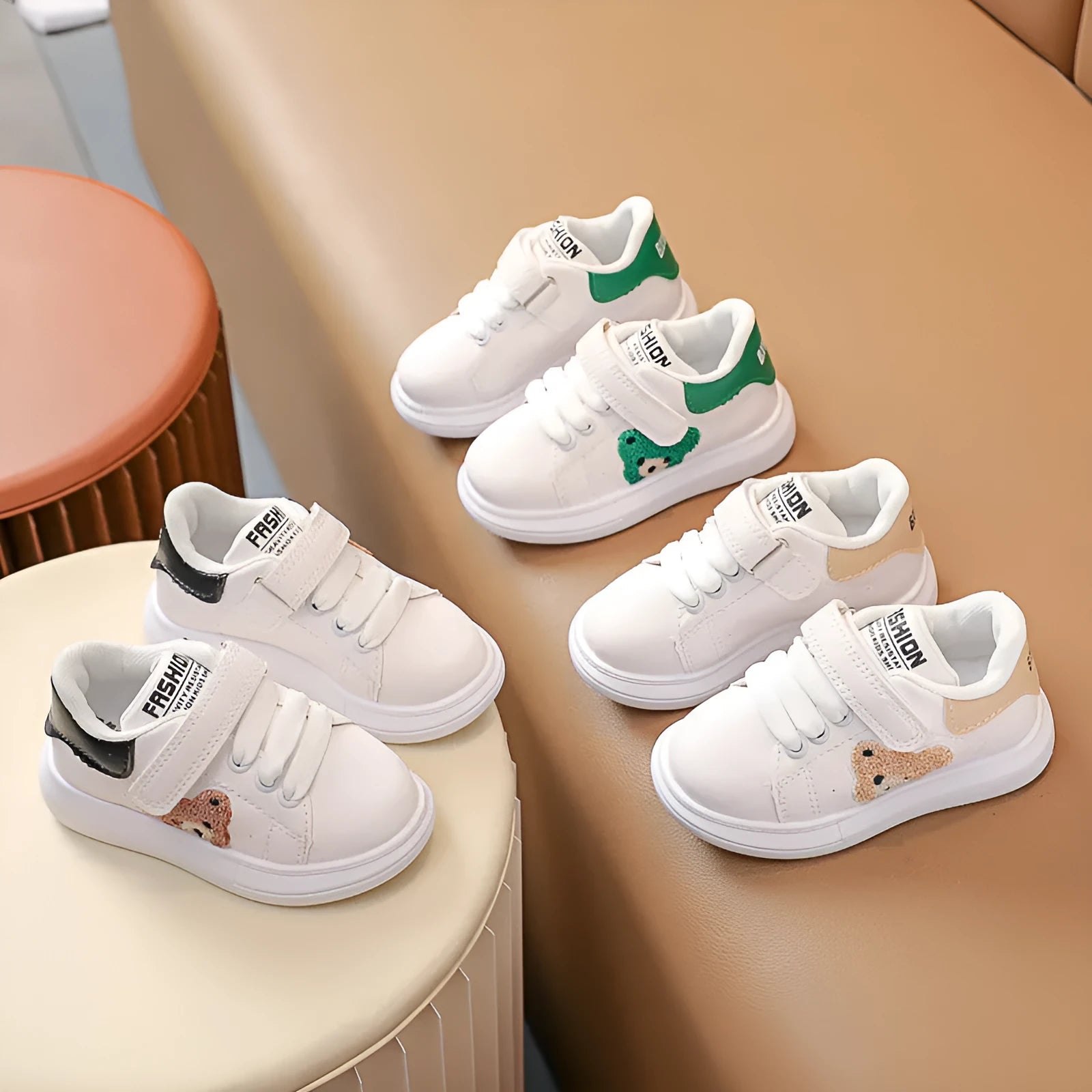 Baby Bear cartoon pattern children's sneakers in green, shown on a white background.