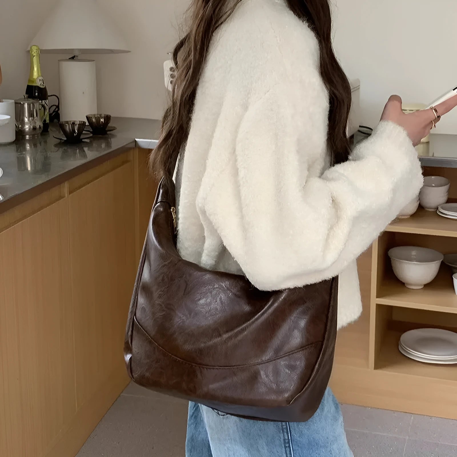 Female retro casual large capacity single shoulder crossbody bag in PU leather, brown, with sewing line detail and dumpling shape