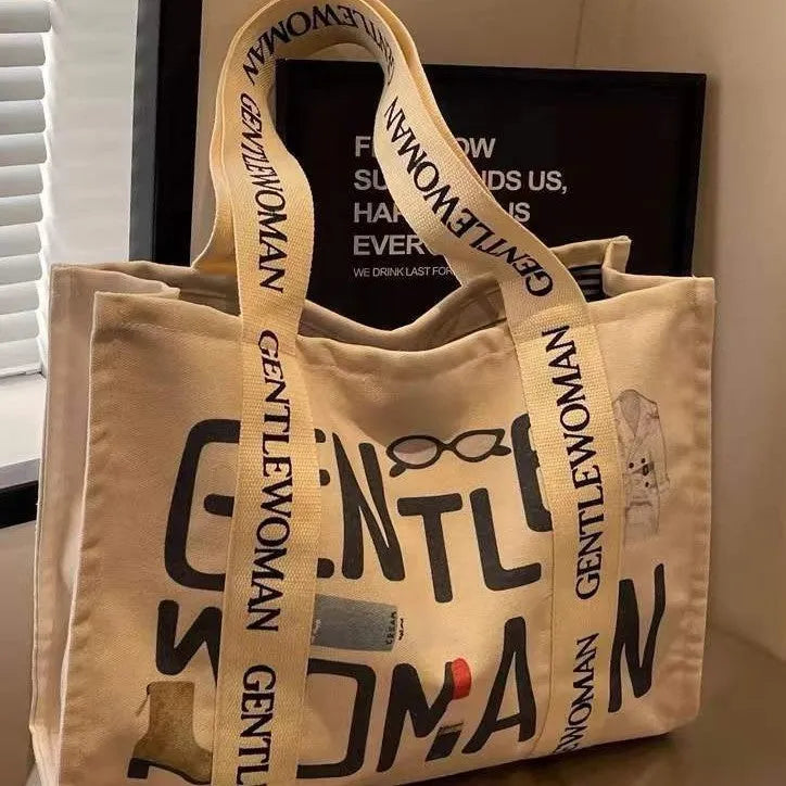 Large canvas women's travel tote bag with shoulder strap and printed design