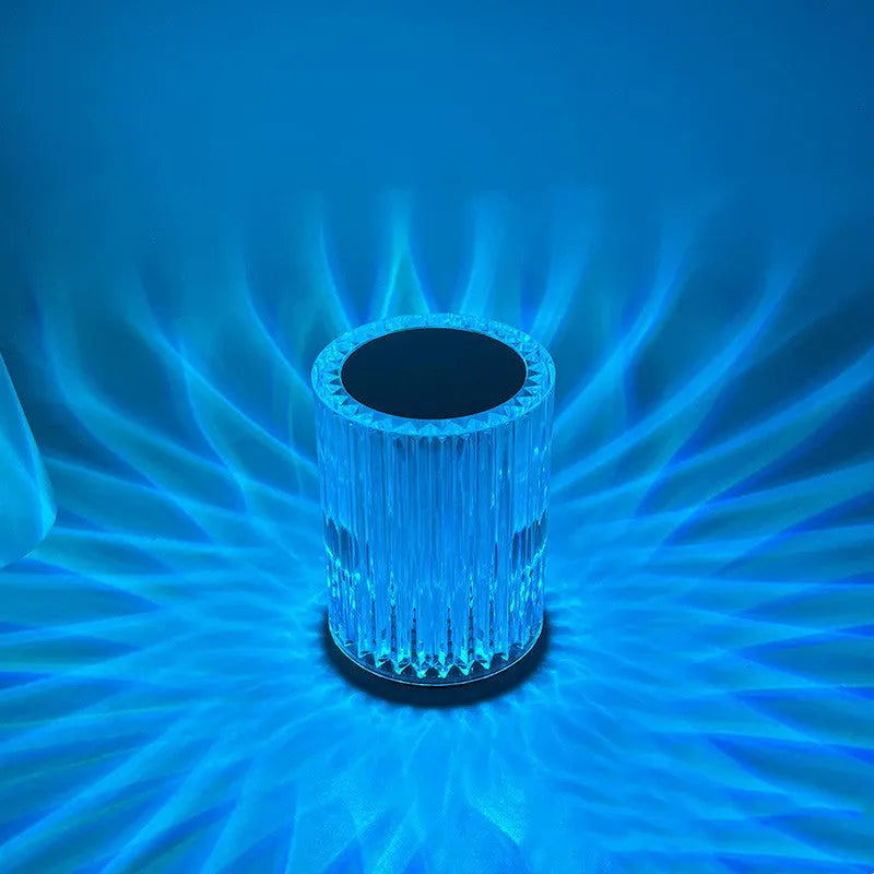 Compact acrylic crystal LED table lamp with RGB colours and remote control on a desk