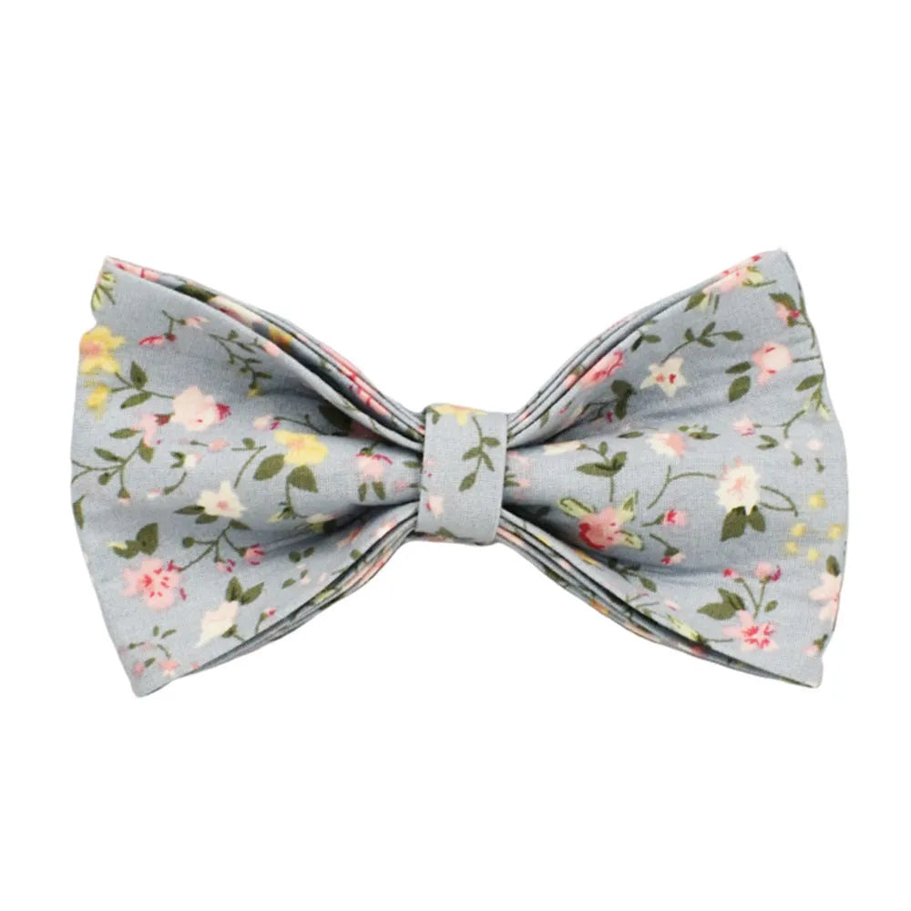 Blue floral patterned adjustable dog collar with matching leash, bow, and vest on a white background.