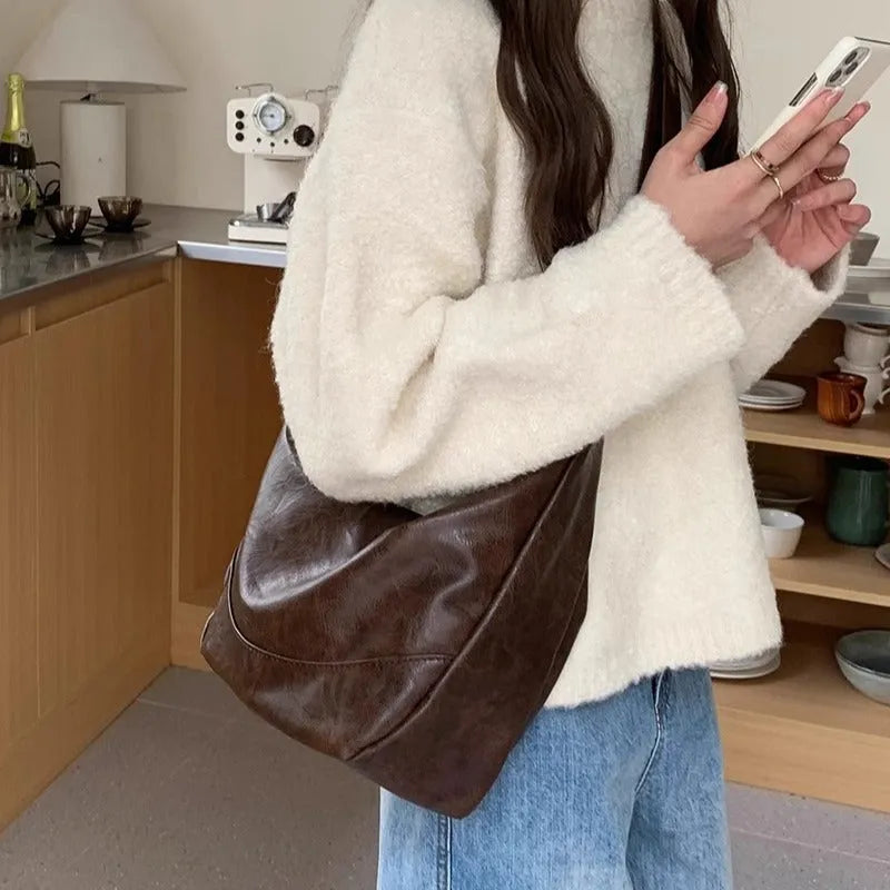 Female retro casual large capacity single shoulder crossbody bag in PU leather, brown, with sewing line detail and dumpling shape