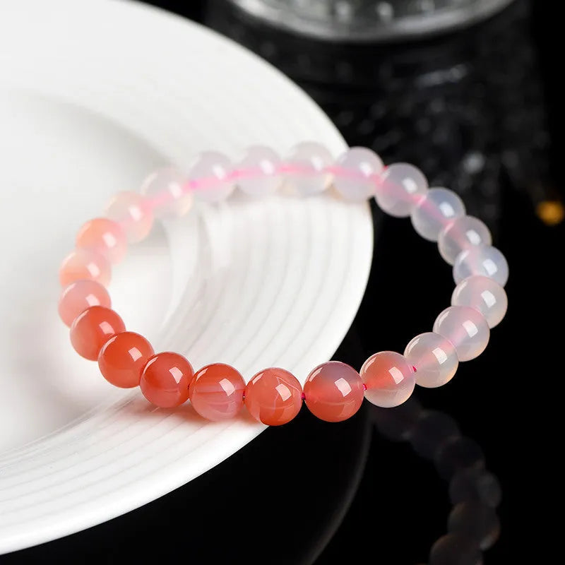 Natural gradient Yanyuan agate bracelet with geometric beads on a wrist, showing salt source colour variation.