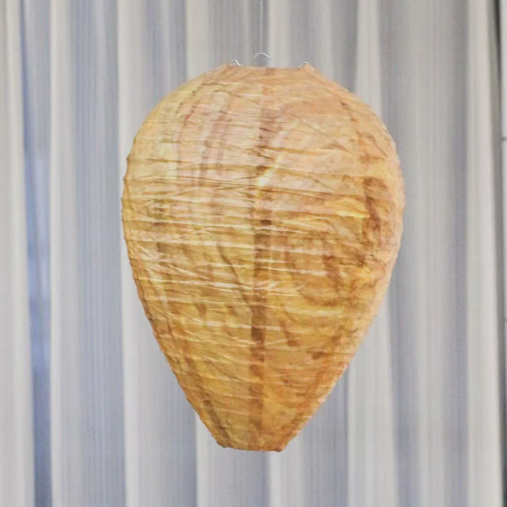 Oval flannel honeycomb lantern for wasp deterrence in a garden setting