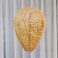Oval flannel honeycomb lantern for wasp deterrence in a garden setting