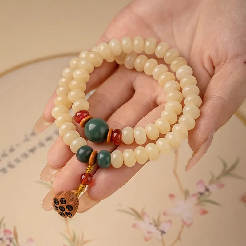 Cream topaz coloured wooden Bodhi root bracelet with flat round beads on a wrist.