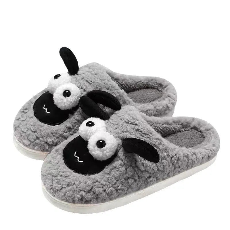 Brown lamb thermal cotton slip-on slippers with suede upper on a wooden floor.
