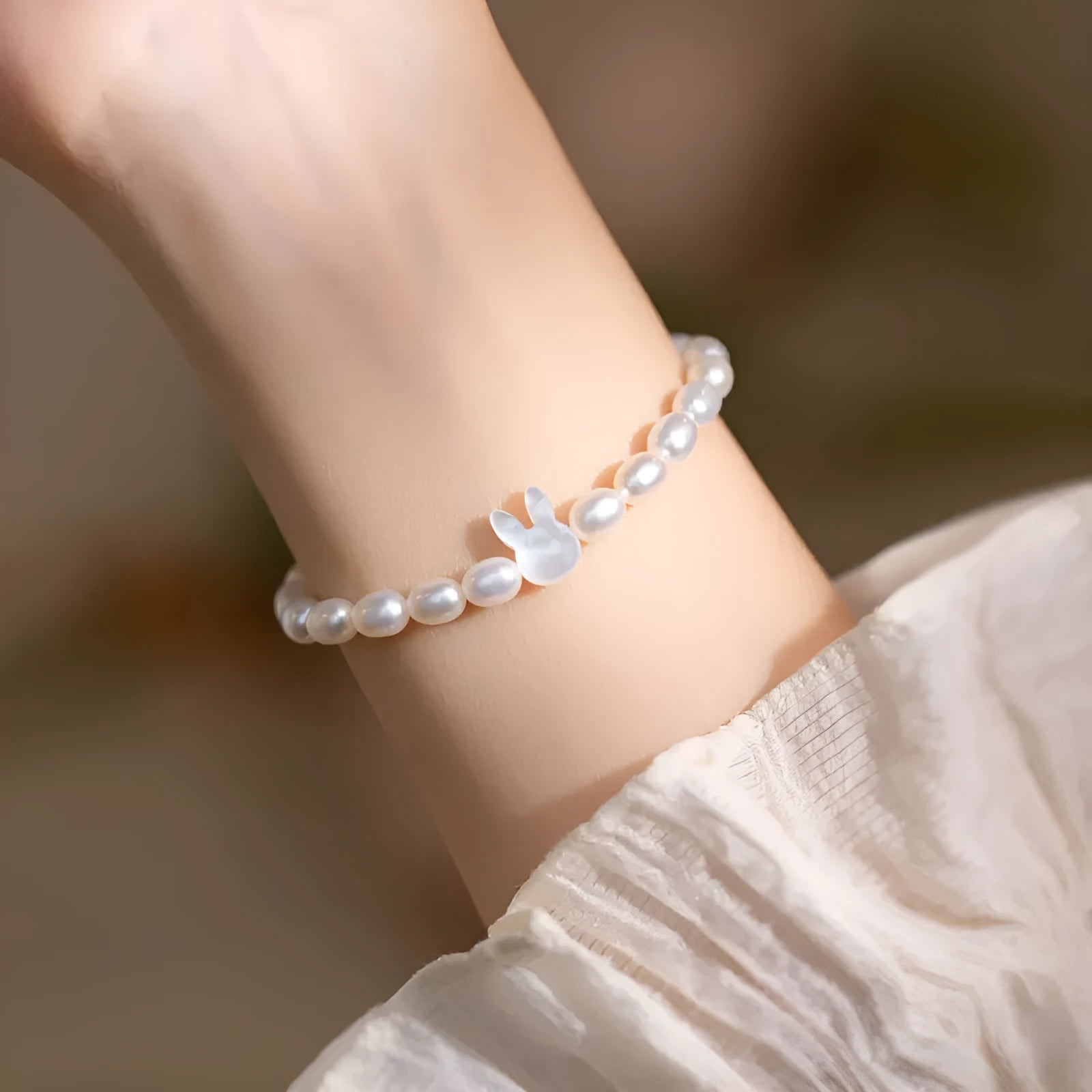 White pearl bead bracelet with 925 silver rabbit charm on elastic string