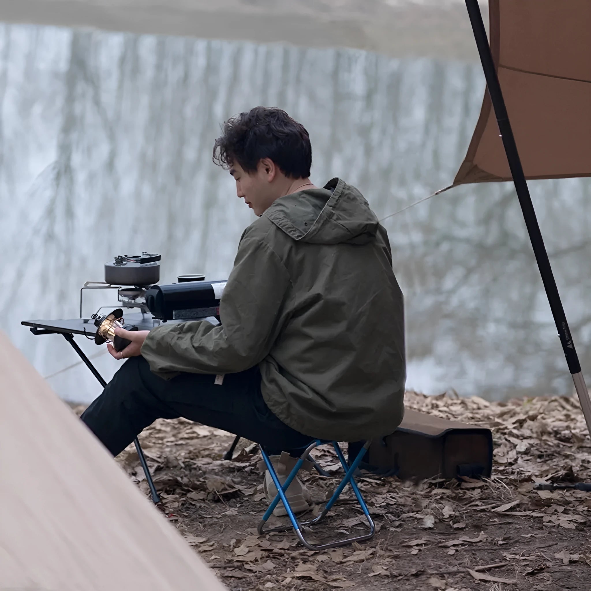 Black ethnic style aluminium alloy portable folding stool for camping and fishing.