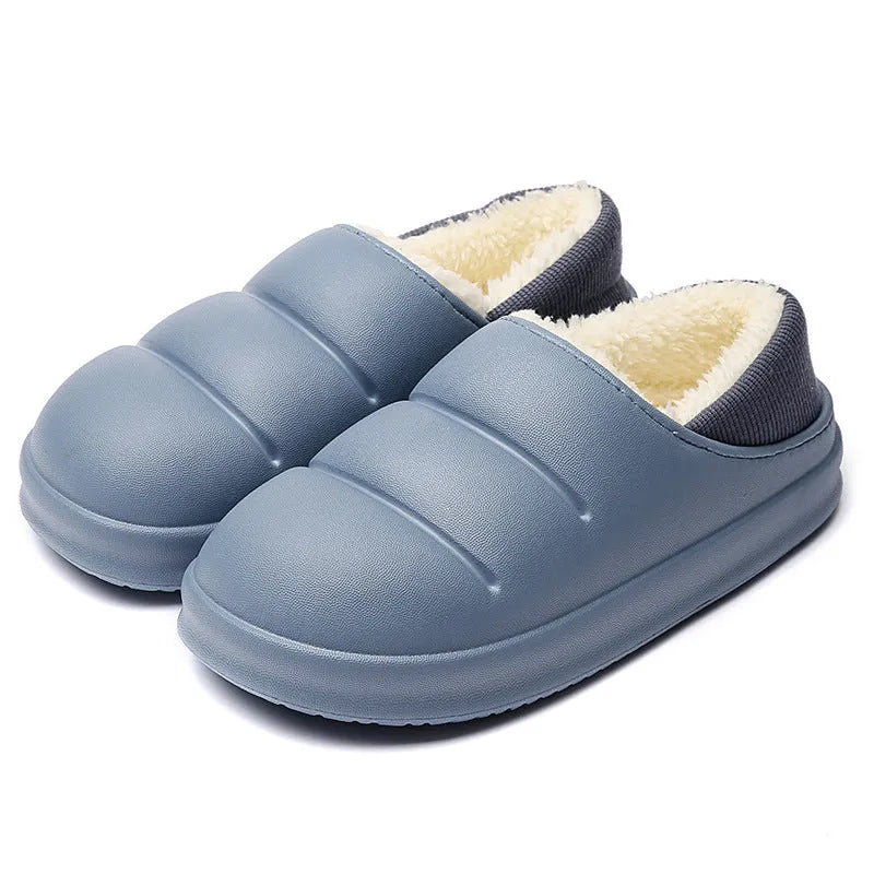 Yellow women's EVA overshoe slippers with plush lining and a textured non-slip sole on a wooden deck.