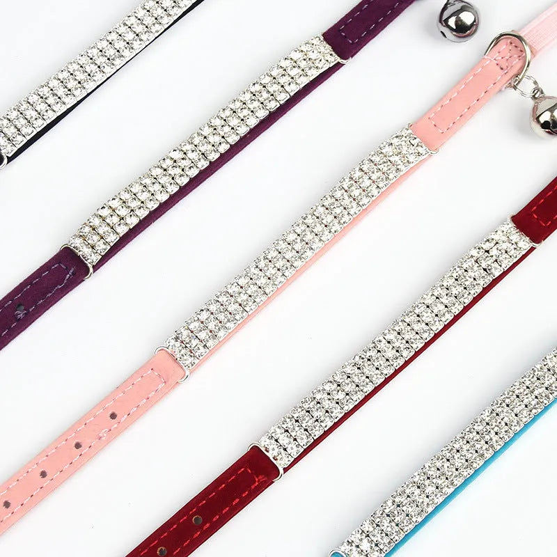 Adjustable velvet cat collar with a rhinestone in red, blue, purple, black, or pink.
