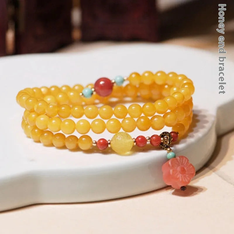 Yellow chicken grease beeswax amber bracelet with 5mm round beads and animal zodiac design.