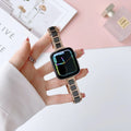 Stainless steel ceramic watch band for Apple Watch 38-49mm in gold with black ceramic finish on a wrist