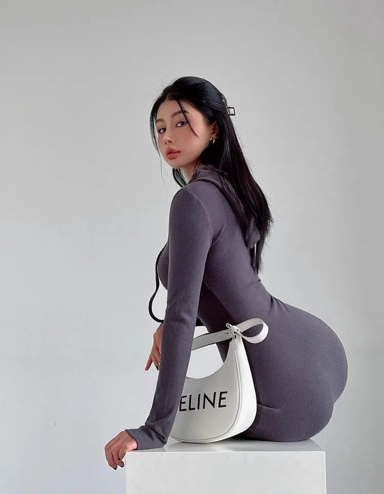A light grey women's hooded sheath dress with long sleeves and a high waist on a model.