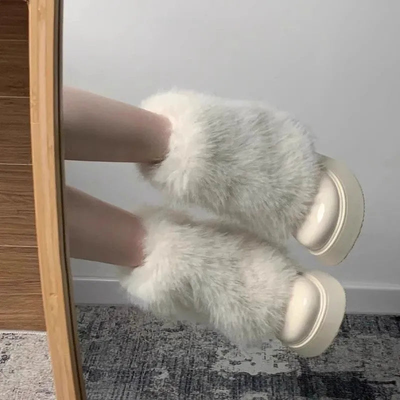 Women's black fleece-lined snow boot with a round toe and mid rubber heel on a white background.