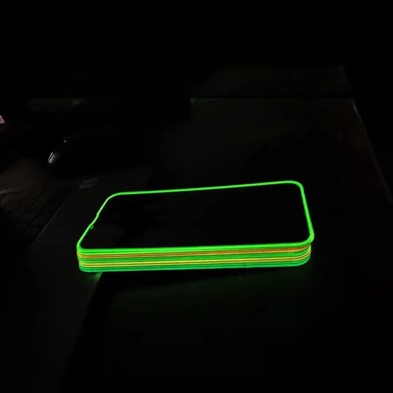 Fluorescent pink luminous tempered glass screen protector fitted on an iPhone.