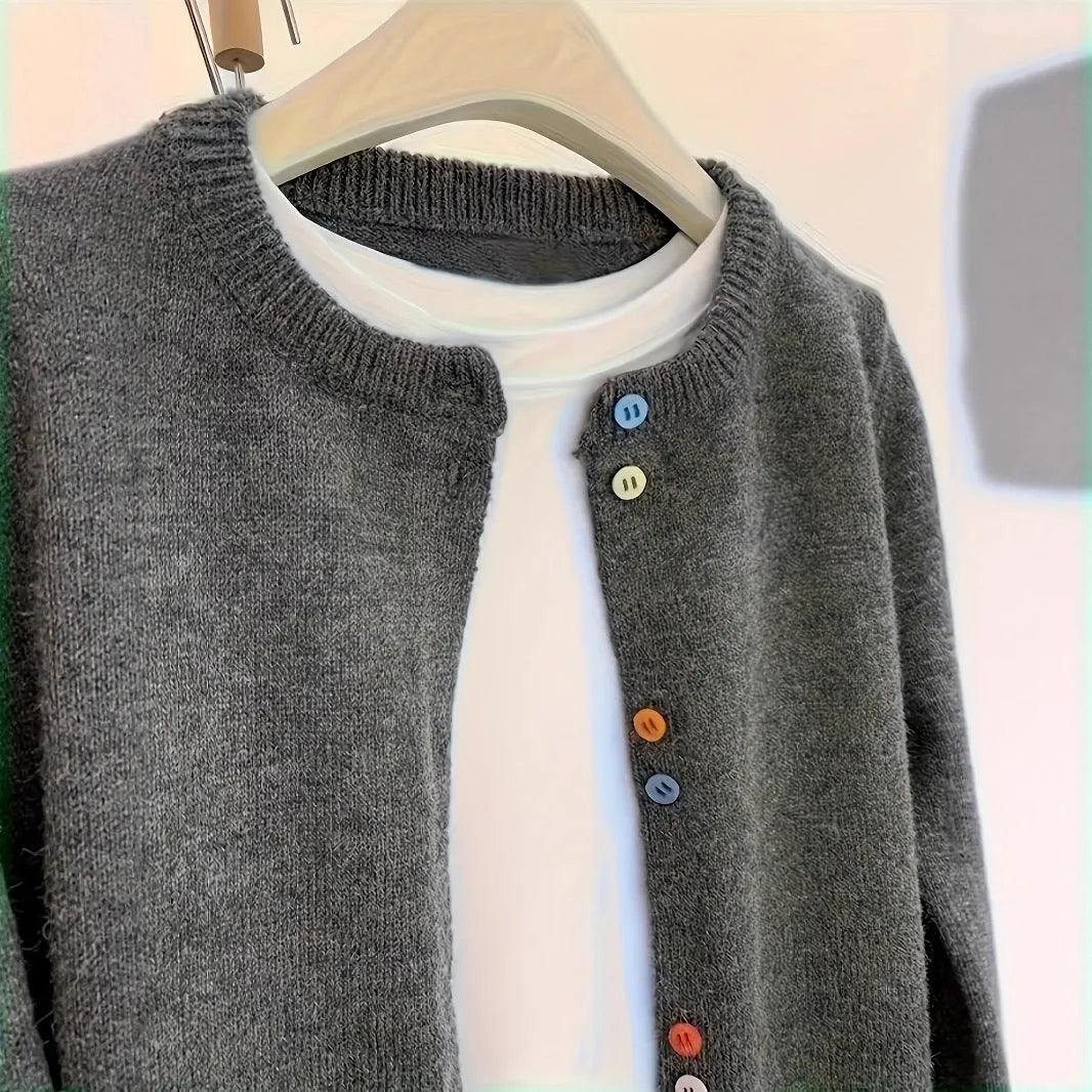Dark grey women's button-up cardigan sweater with long sleeves on a hanger.