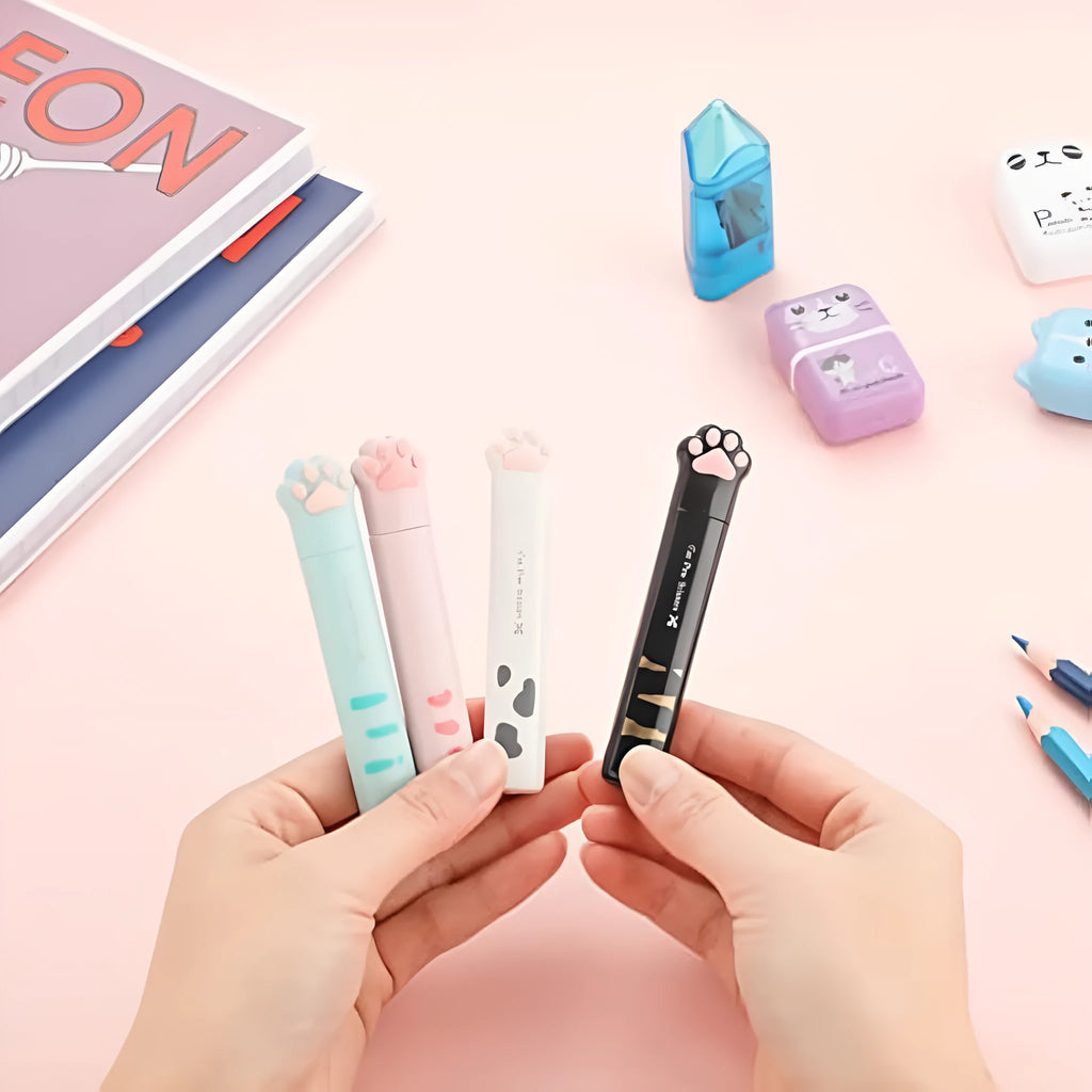 Cat paw cartoon design mini folding safety scissors in four colours: black, blue, pink, and white.