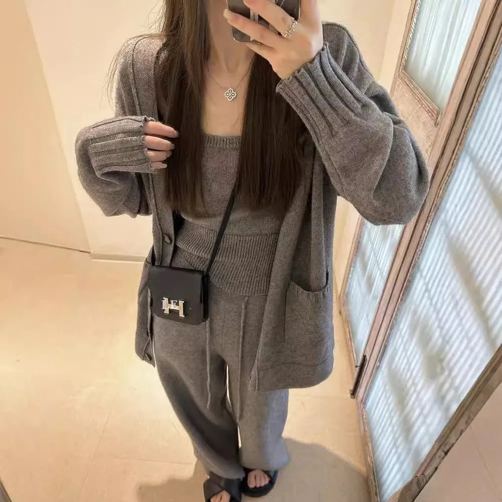 Women's light brown knit cardigan, vest, and casual pants three-piece set laid flat.