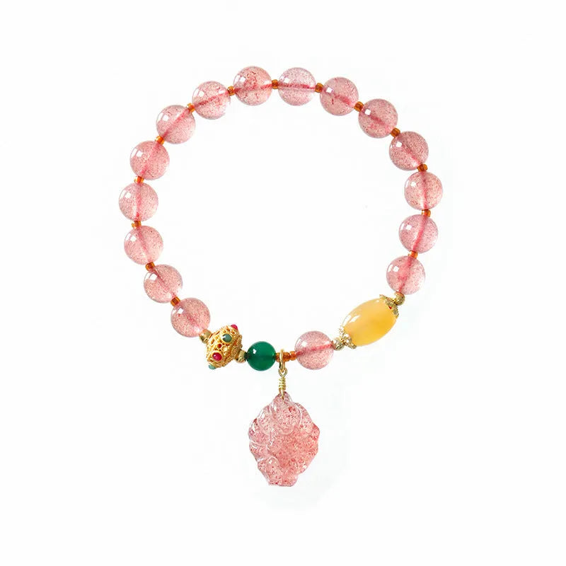 Women's crystal bracelet with nine tail fox design in polished natural strawberry quartz beads