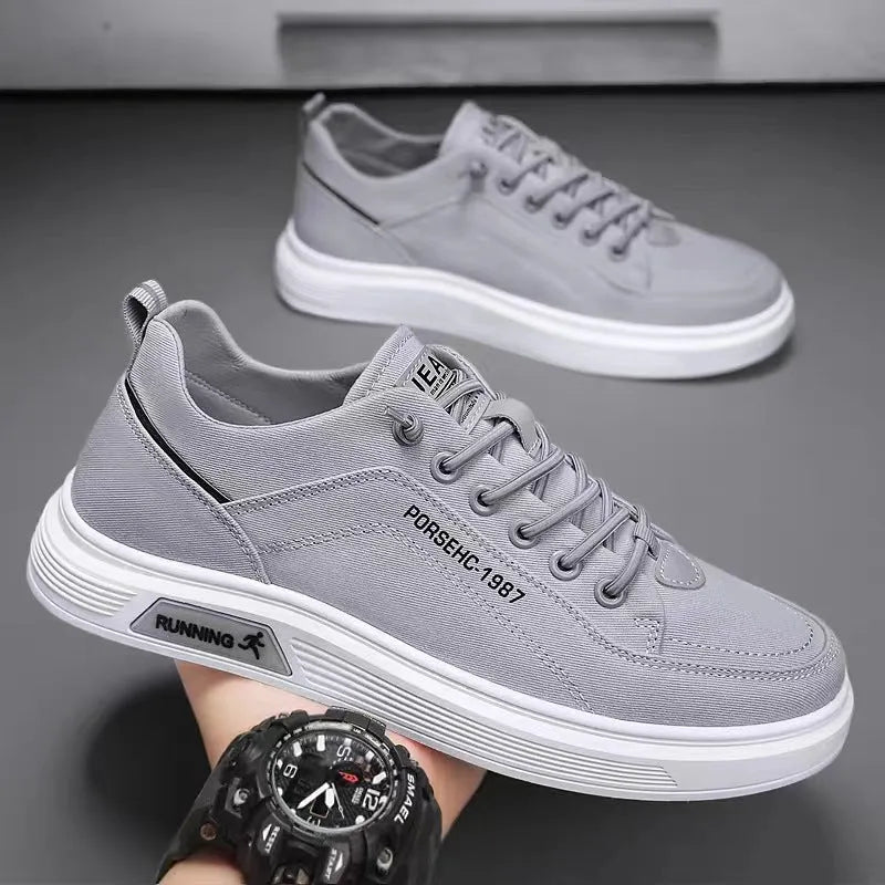Men's grey canvas flats shoes with front lace-up stitching and shallow mouth design, side view
