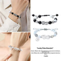 Hand-woven couple bracelet with sterling silver blessing card in black, white, or set, featuring animal and tassel details.