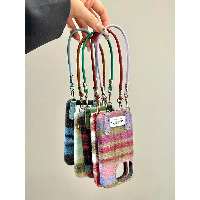 Flannel plaid phone case with wristband in black green and red checkered, compatible with iPhone models.