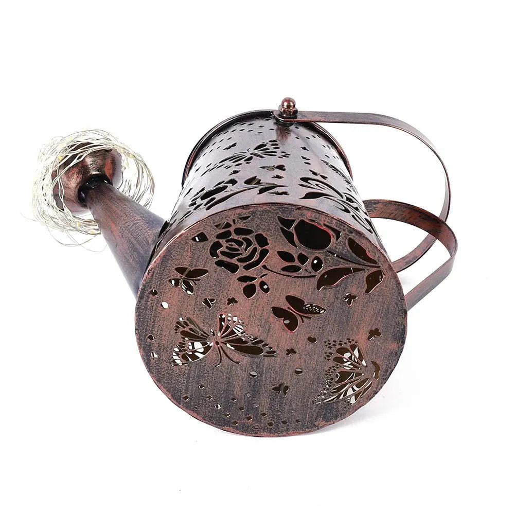 Iron solar garden lamp with tapered butterfly pattern and warm white LED light.