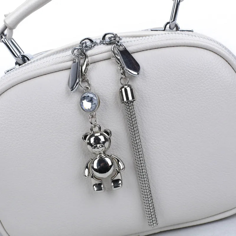 Oval-shaped women's small square shoulder bag in PU with double straps, shown in blue.