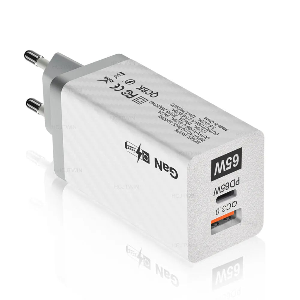 White and black 65W GaN USB-C laptop travel charger with UK, US, and EU plug options