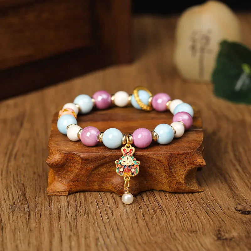 Handmade grey ceramic bracelet with rabbit charm and porcelain glaze finish