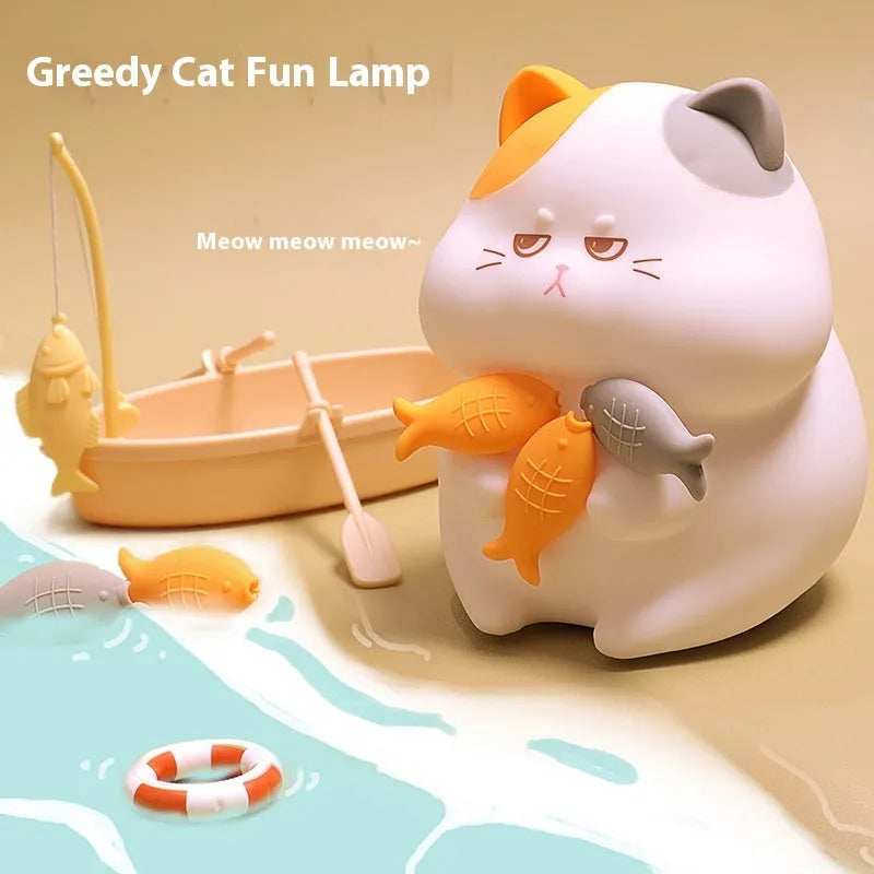 Small greedy cat cartoon desktop night light with yellow fin tuna design on a desk.