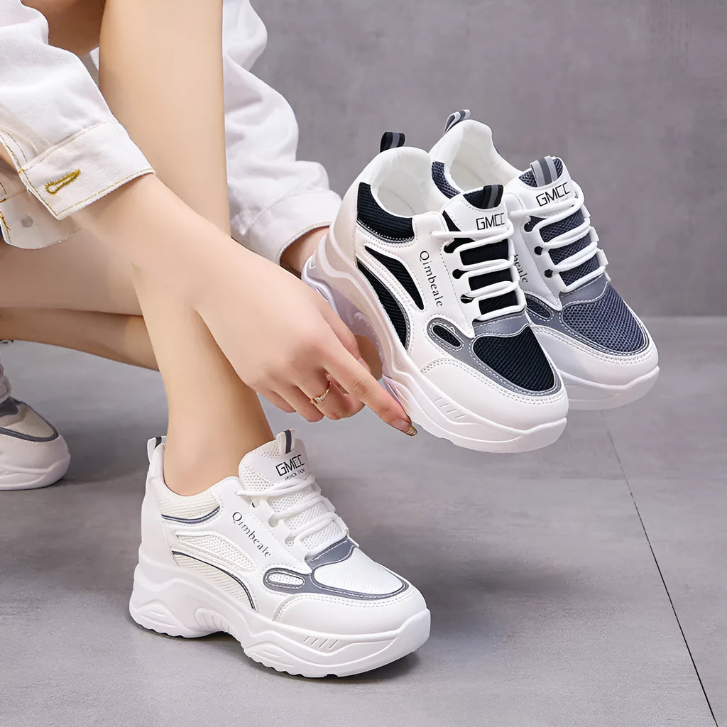 White height increasing dad shoes with mesh upper and wedge heel on a neutral background