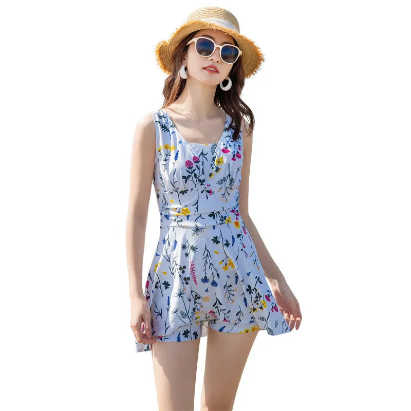 Women's light purple and white floral print one-piece swimsuit on a hanger.