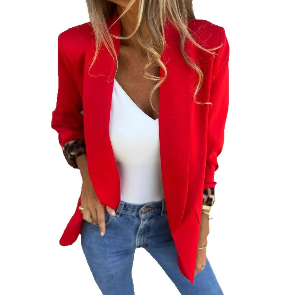 Woman wearing a slim fit black blazer with a bold 3D cheetah animal print pattern.